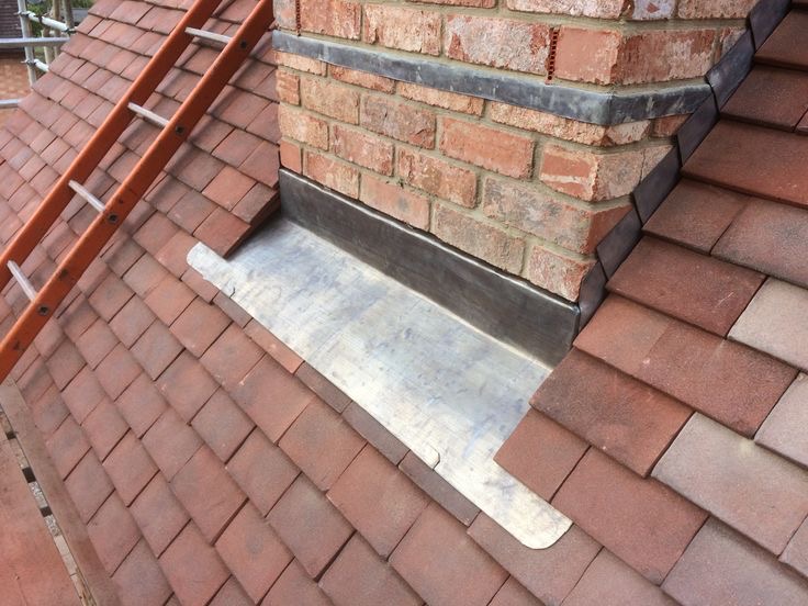 Lead flashing detail around a brick chimney
